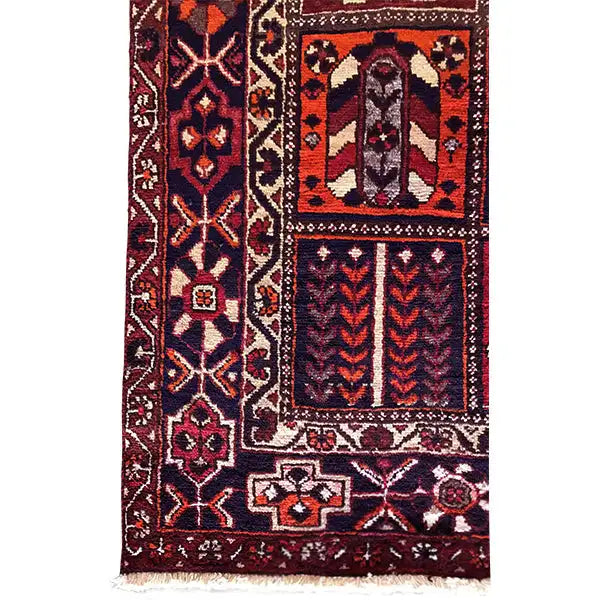 Carpet detail with ornaments, diamonds, and decorative borders in burgundy, blue, and cream