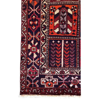 Carpet detail with ornaments, diamonds, and decorative borders in burgundy, blue, and cream