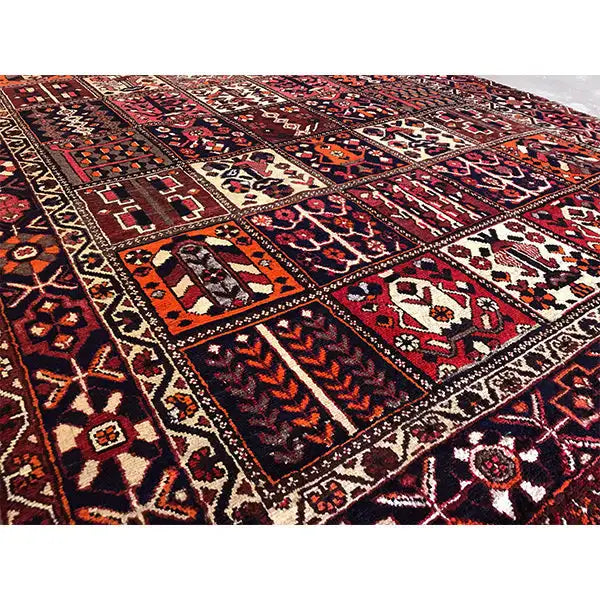 Rug with a high-contrast border pattern and geometric motifs in burgundy and beige