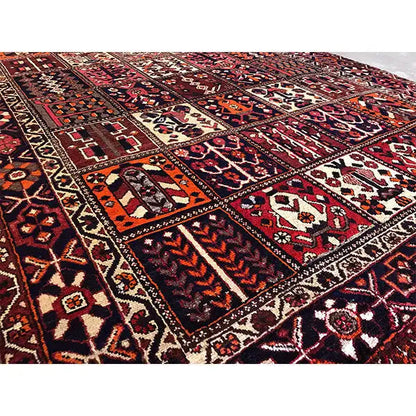 Rug with a high-contrast border pattern and geometric motifs in burgundy and beige