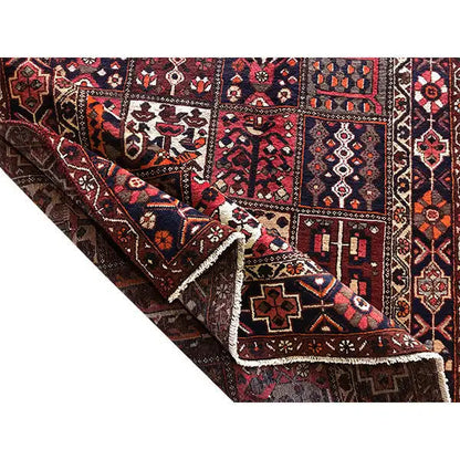 Rug edge with fringe; patchwork motifs in dark blue, burgundy, and cream