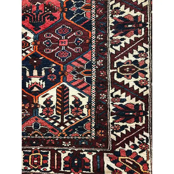 Persian rug with border and geometric pattern, dark red, blue, beige