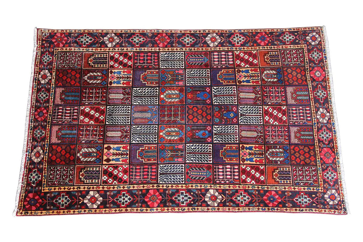 Oriental rug with a geometric pattern in red, blue, and beige, spread out in a rectangular shape