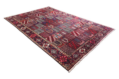 Rectangular oriental rug in red, blue, and beige with an intricate ornamental pattern