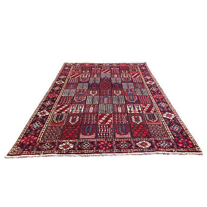 Oriental rug laid flat with geometric shapes in red and blue