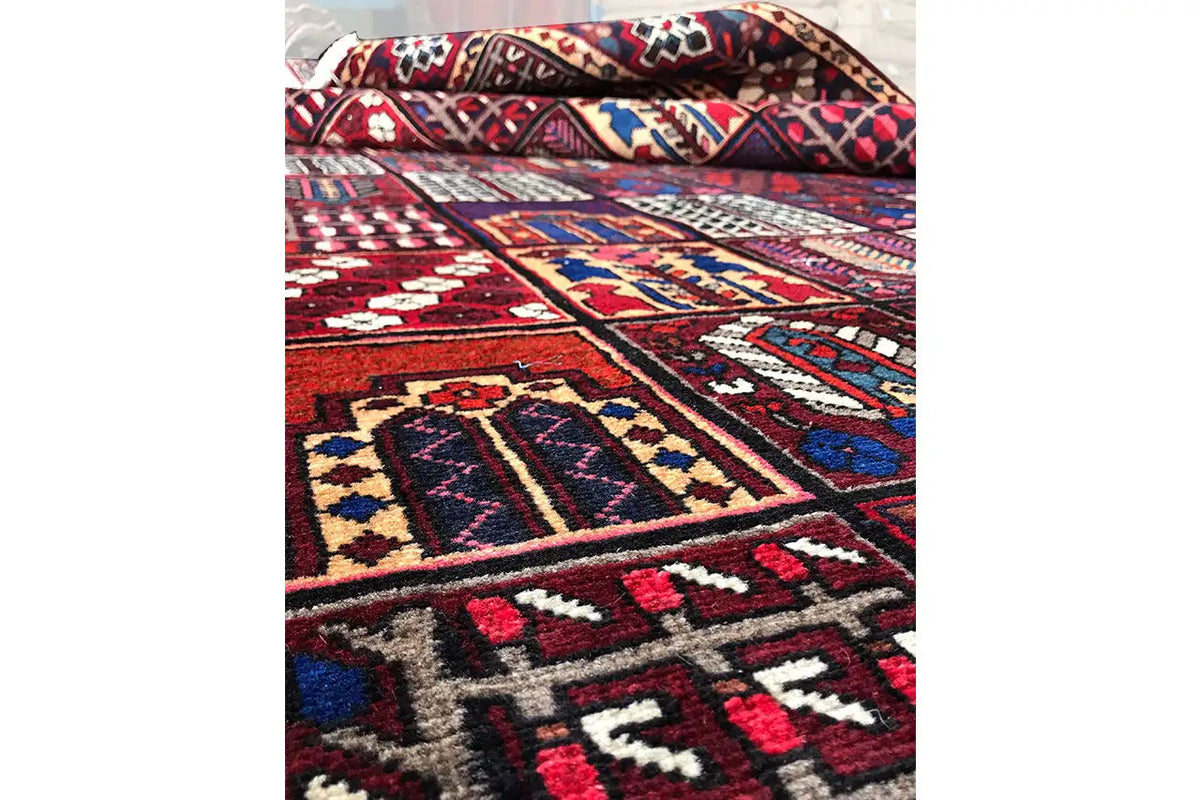Side detail of the carpet with borders in red, blue, beige, and white