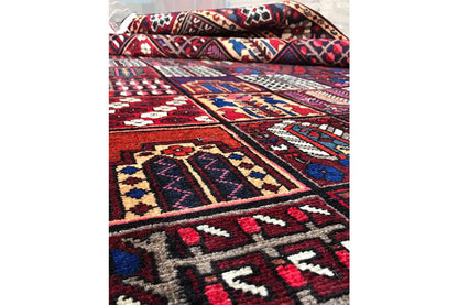 Side detail of the carpet with borders in red, blue, beige, and white