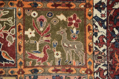 Oriental rug with a square pattern and animal/plant motifs in green, red, and blue