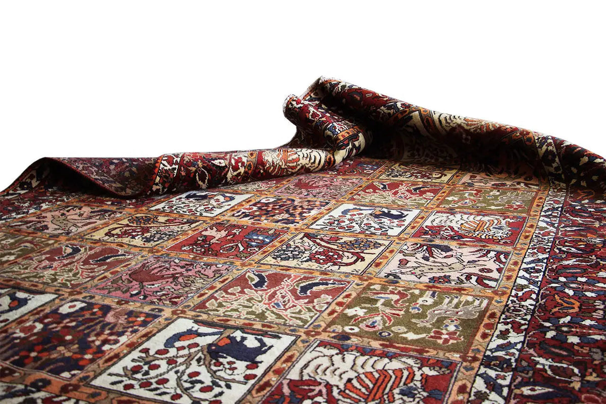 Oriental rug laid out, with colorful patterned sections and floral ornaments in red and blue