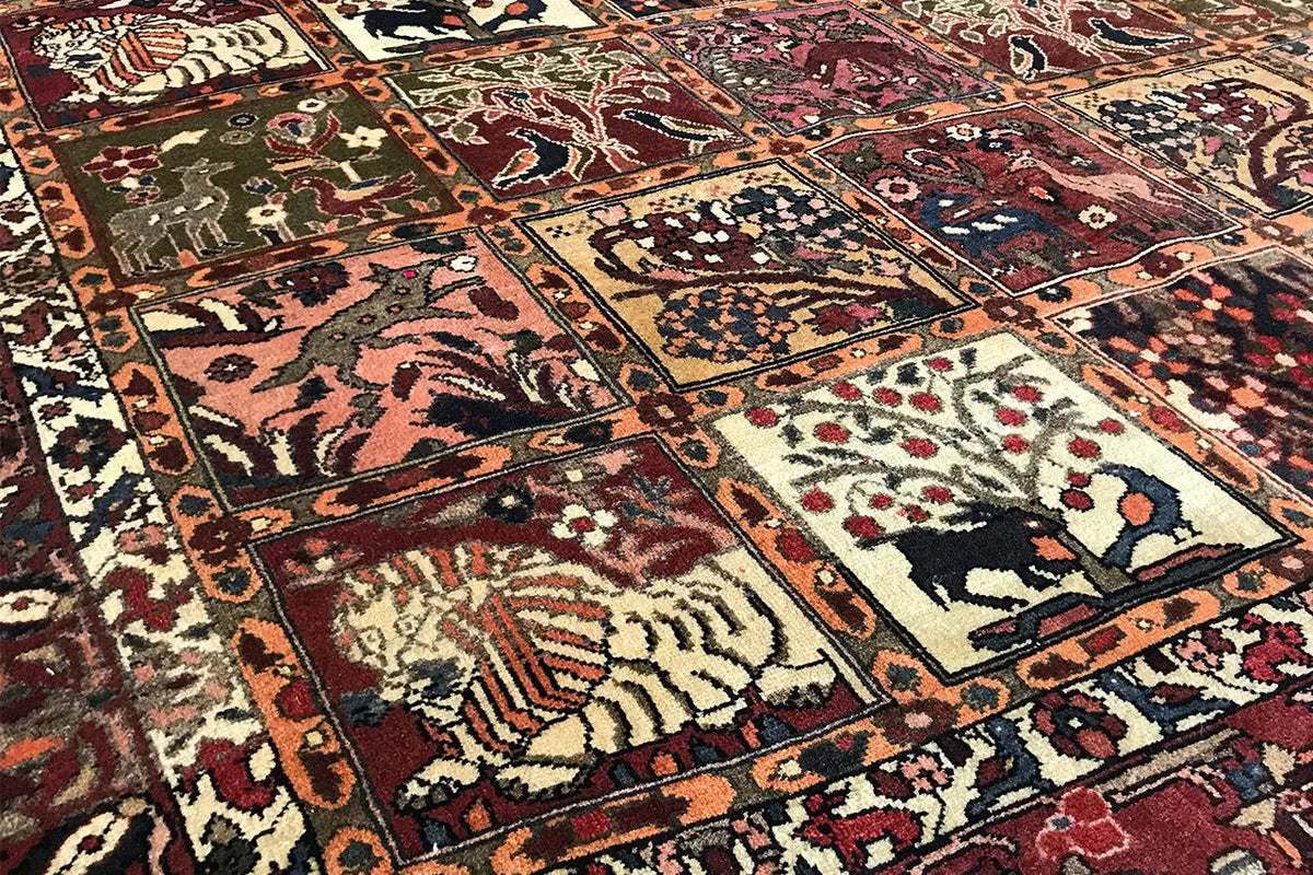Close-up: Oriental rug details with animal motifs, vines, and decorative border in red and blue