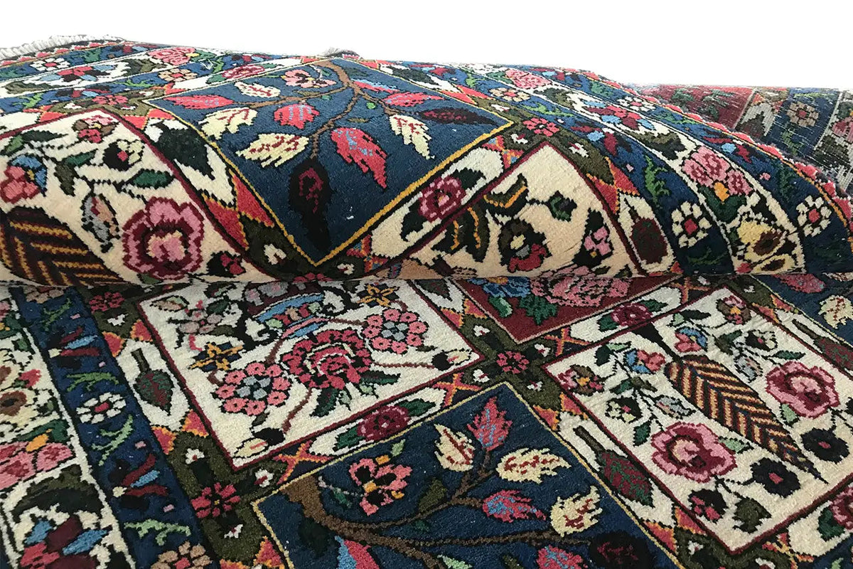 Close-up of the oriental rug: floral and geometric motifs in a patchwork design.
