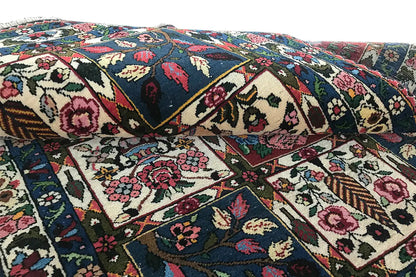Close-up of the oriental rug: floral and geometric motifs in a patchwork design.