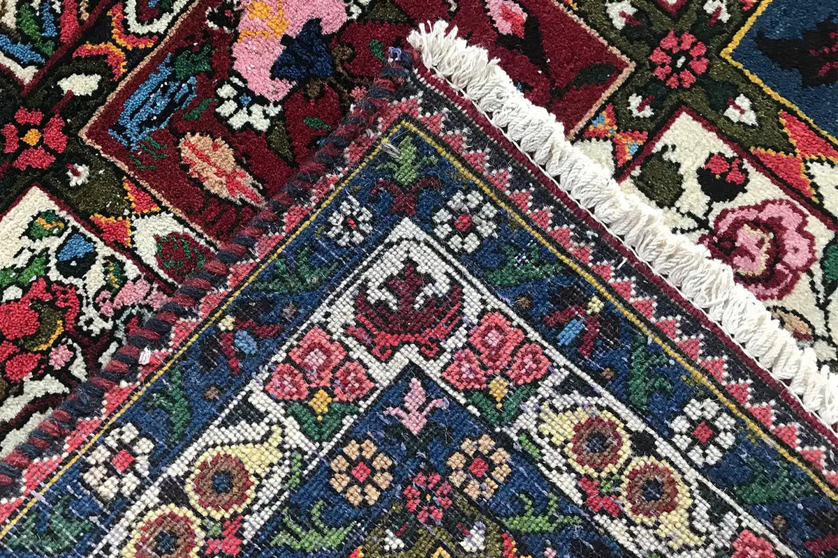 Close-up: carpet with a dense pattern, dark blue background, and pink accents.