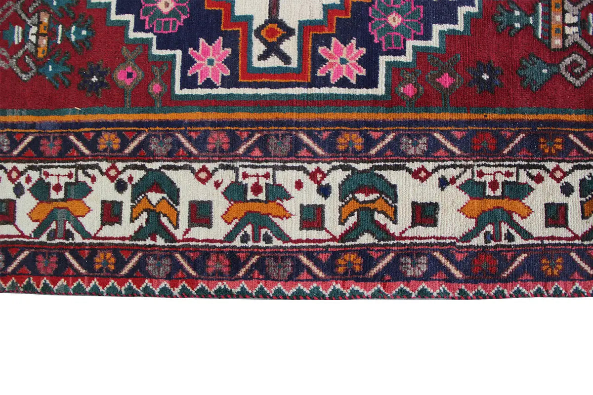 Close-up of the border on the oriental rug, a patterned strip with zigzag and tile ornaments