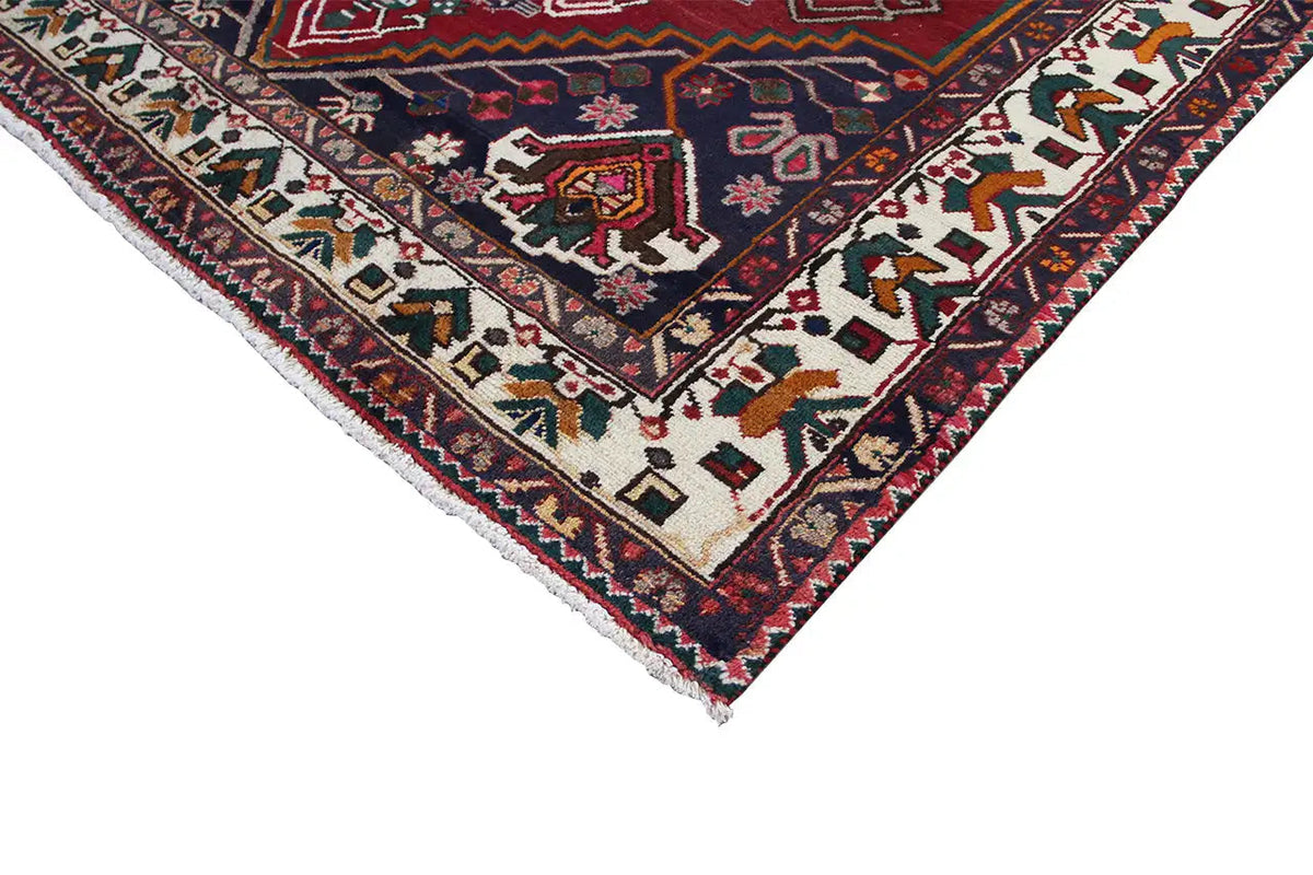 Corner of an Oriental rug with border ornaments, red and dark blue background, light accents