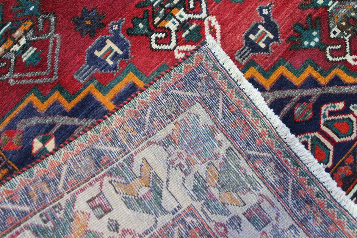 Detail at the corner area: stepped patterns, light-colored fringes/fabric edge, red and blue
