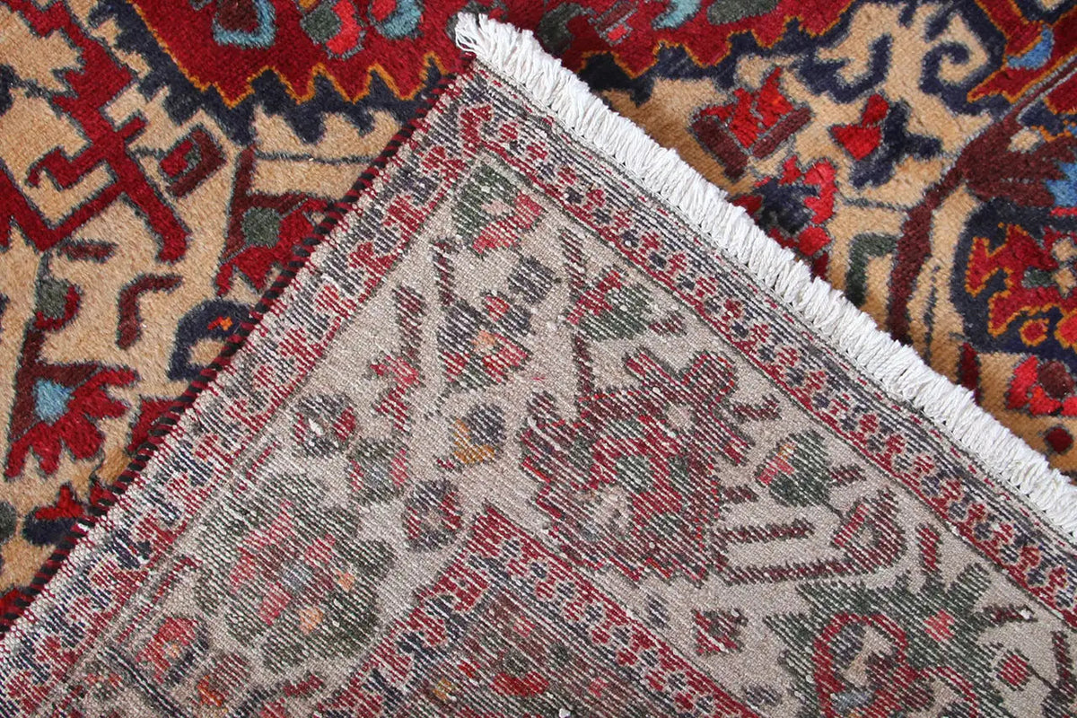 Close-up of a carpet edge with a short fringe trim and dense pattern