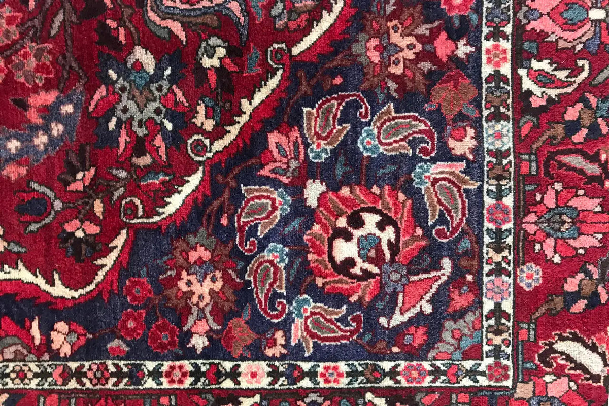 Detailed close-up: red ornamental design with dark blue accents and fine lines.