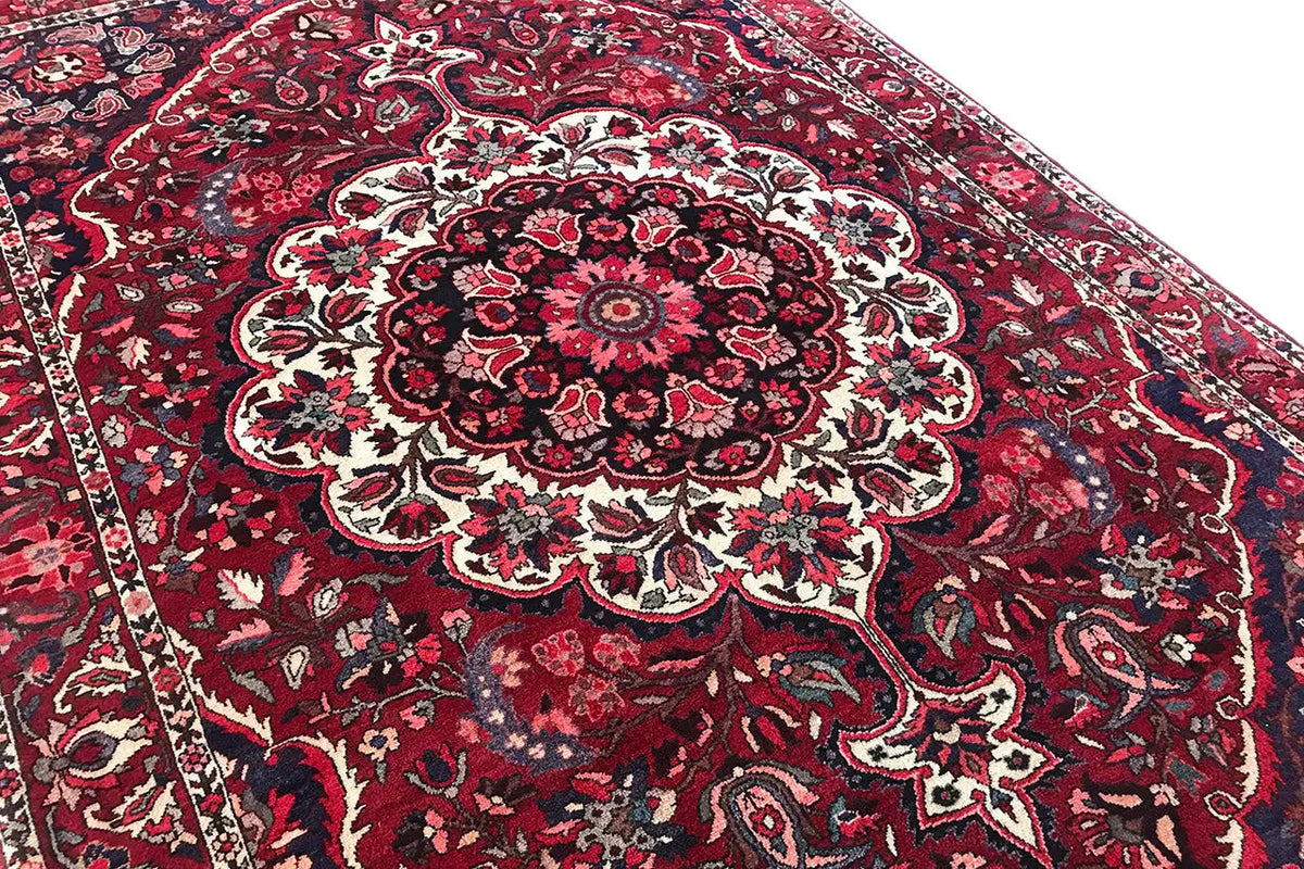 Central medallion in the Bakhtiari rug, red ornamental design with a light border.