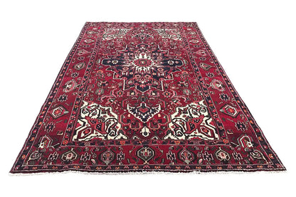 Bakhtiari rug, rectangular, red with a blue border and ornamental white patterns