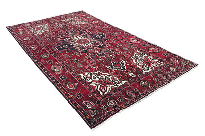 Rectangular oriental rug, red and blue color scheme with light medallions and scrolling vines
