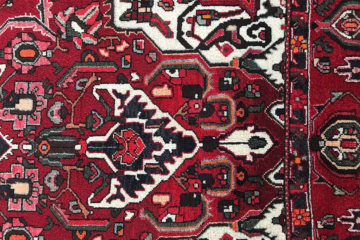 Carpet detail: ornamental patterns in red, dark blue, black and off-white