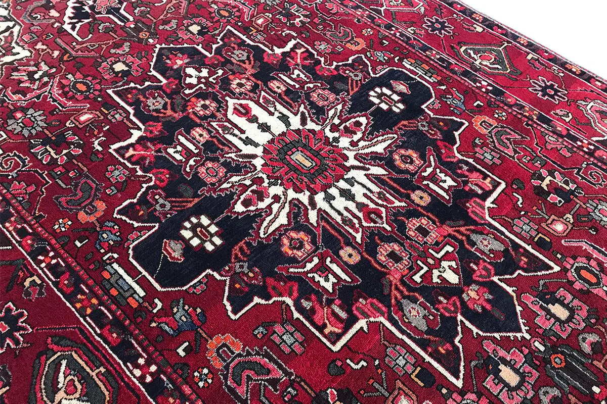 Close-up of a carpet area with a medallion pattern in red, blue, and white