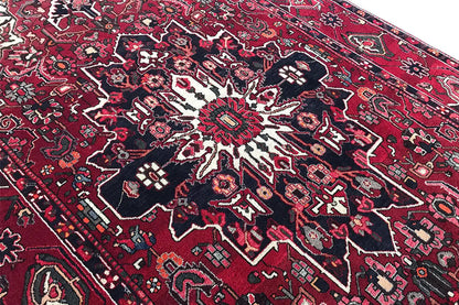 Close-up of a carpet area with a medallion pattern in red, blue, and white