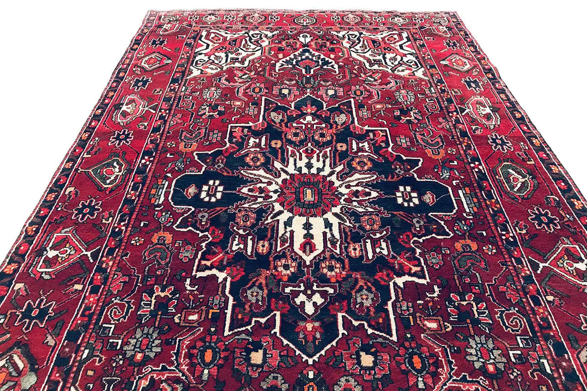 Central medallion rug: red with a dark blue pattern and white accents