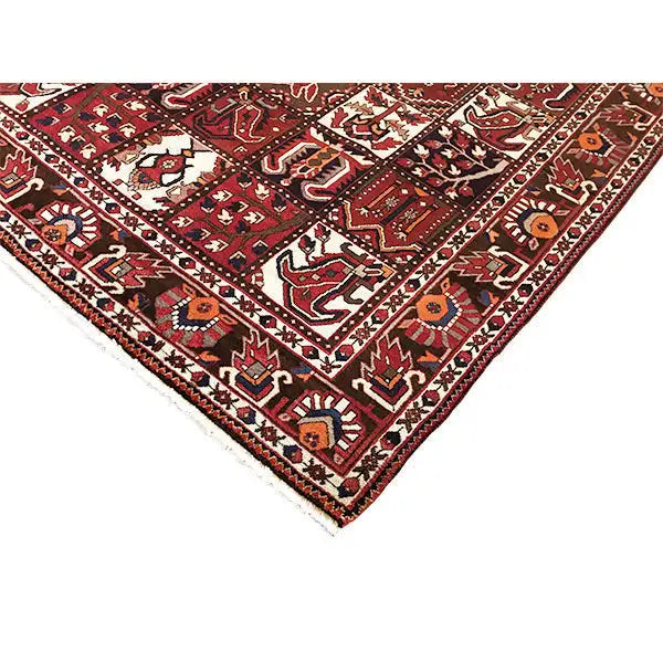 Bakhtiari rug with corner view: burgundy-red field, cream-colored ornaments and borders