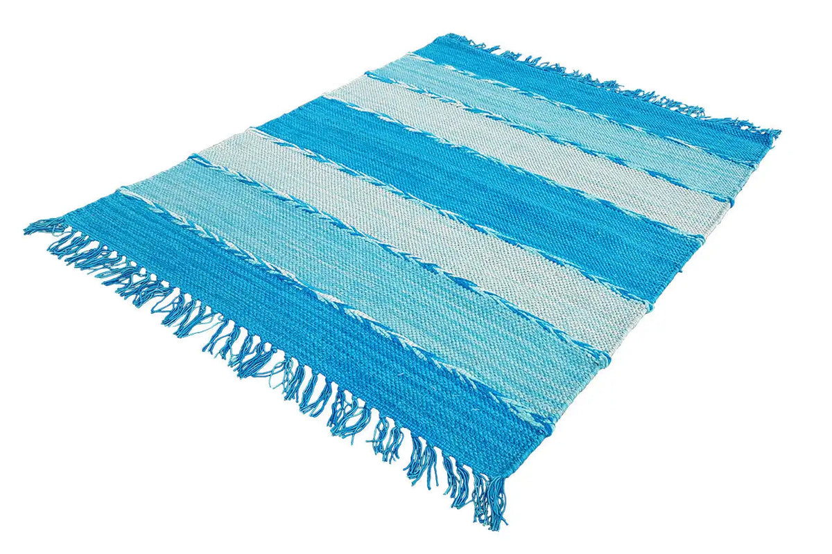 Kilim dhurrie rug at an oblique angle, blue stripes and fringes on the sides