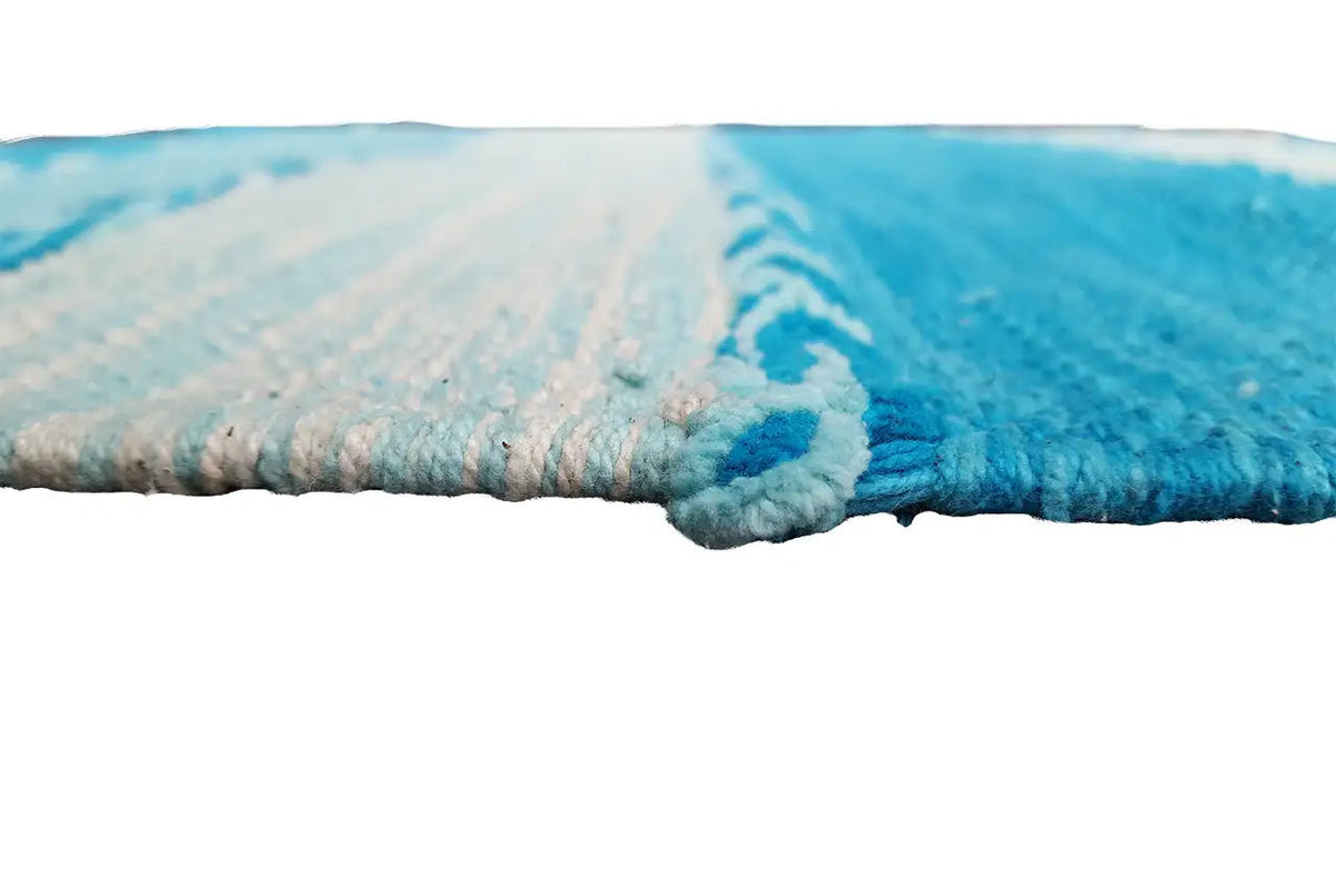 Kilim dhurrie rug edge with fringe and turquoise woven pattern
