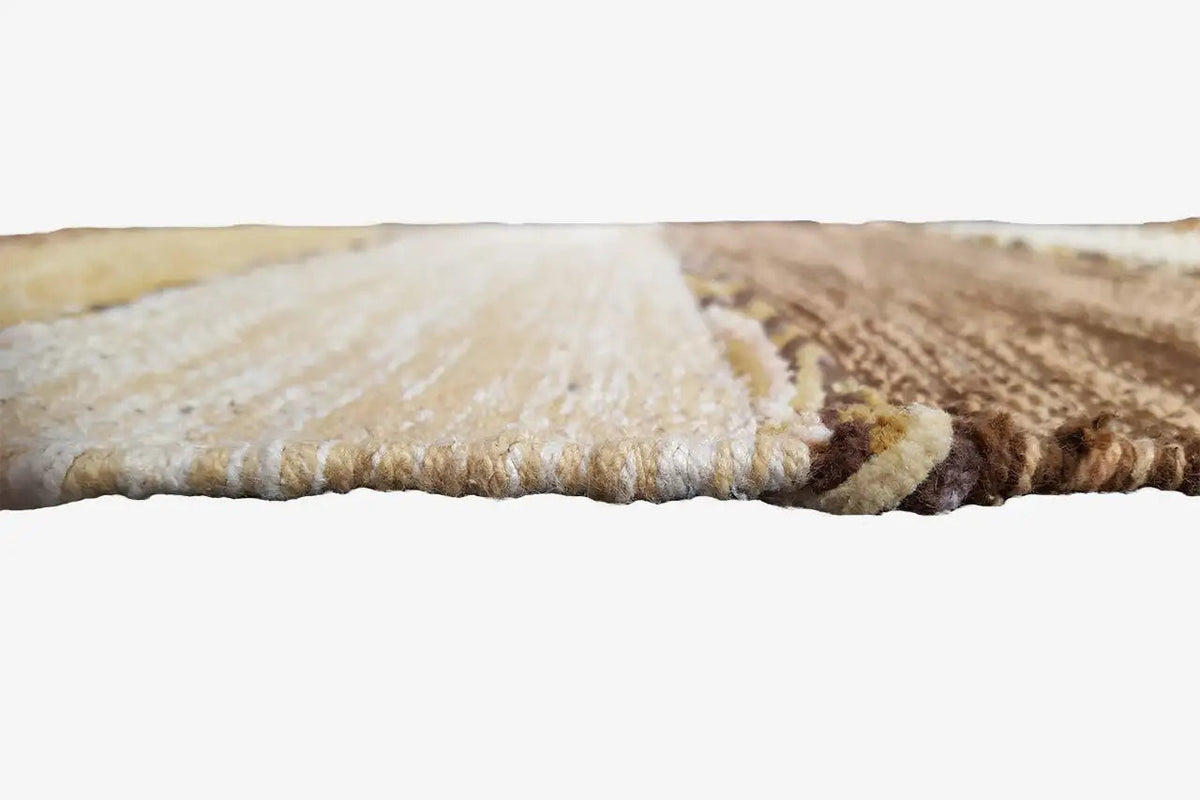 Close-up of the carpet edge: woven surface with a brown finishing strip