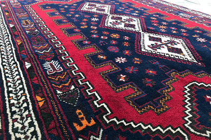 Carpet detail with a red central stripe and a blue-and-white zigzag border