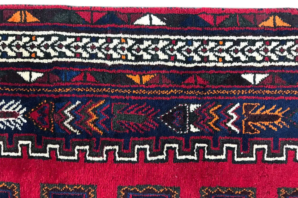 Close-up: carpet edge with red and blue ornaments and fringes