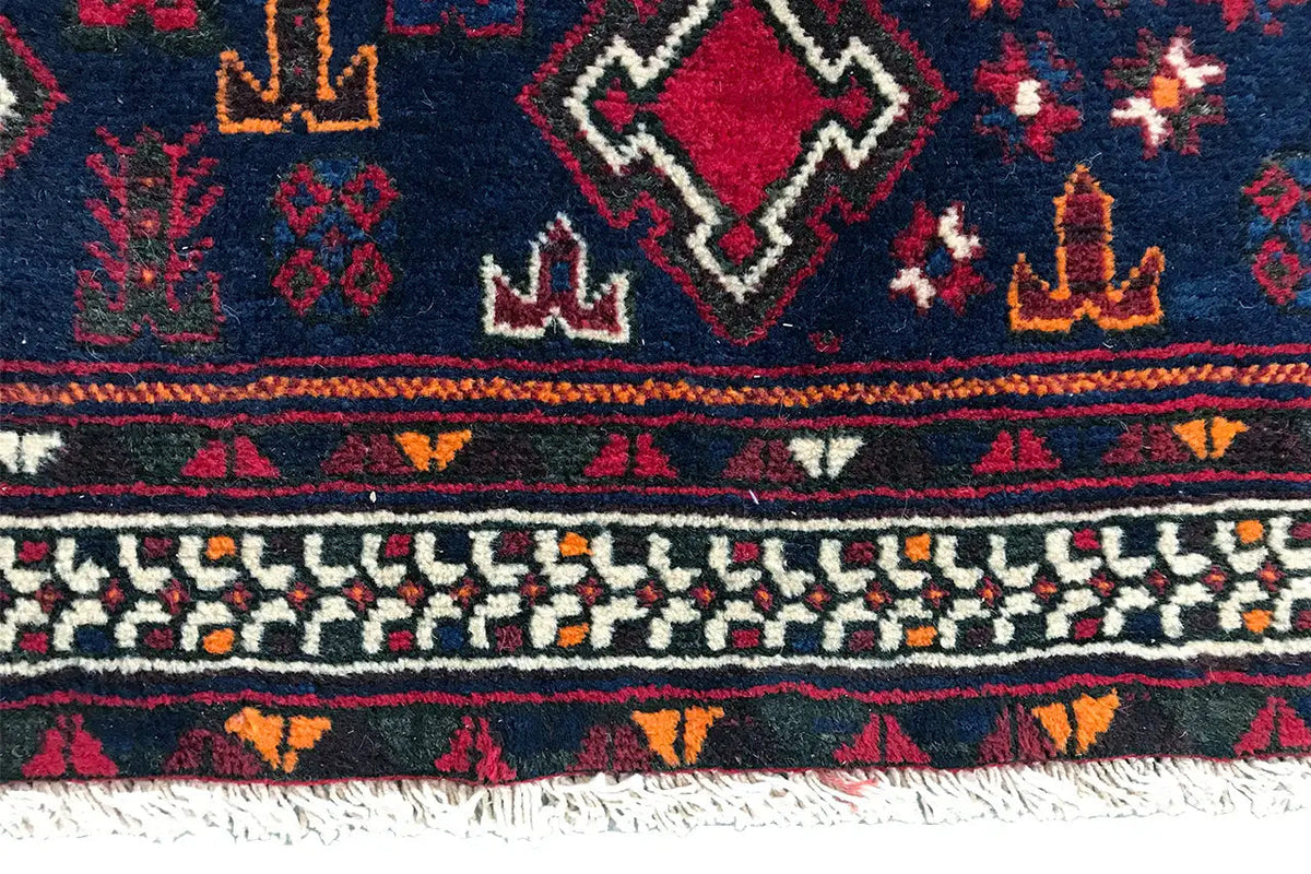 Rug edge with fine decorative bands, small symbols, and fringes