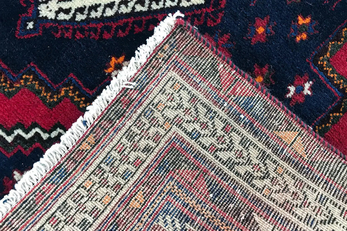 Carpet detail with a white-beige base weave and colorful ornaments