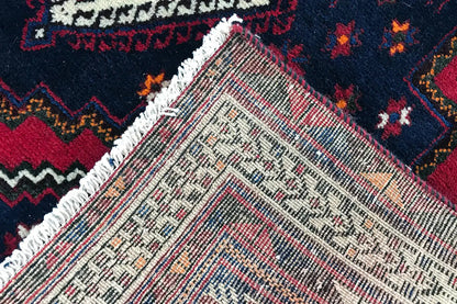 Carpet detail with a white-beige base weave and colorful ornaments