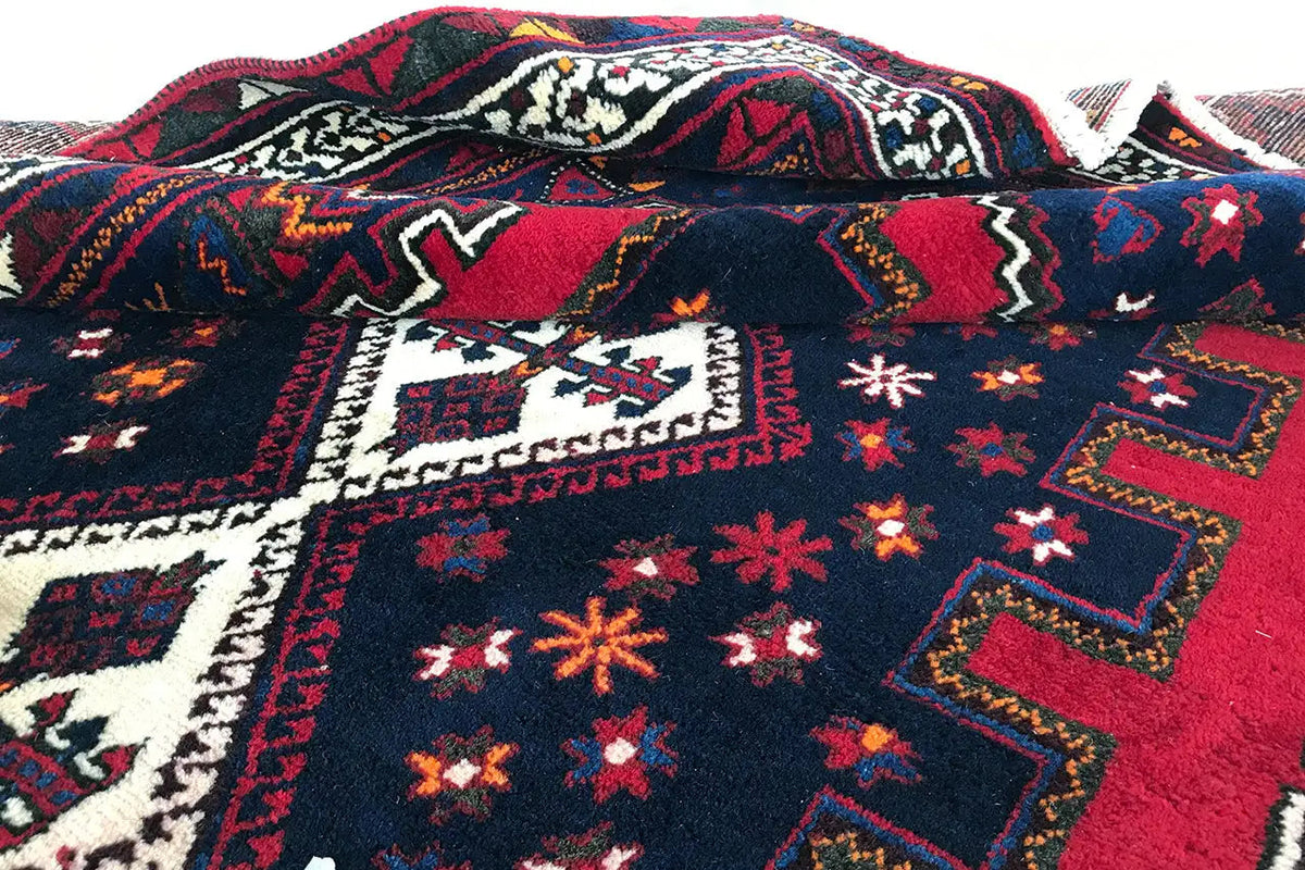 Rug with red field and medium-blue medallion design
