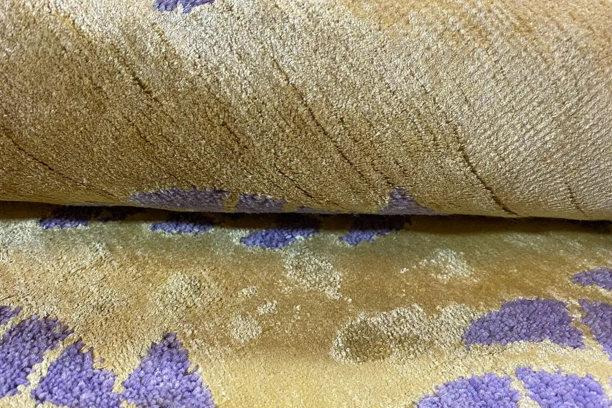 Designer carpet surface with a distinct texture, yellowish and purple color accents