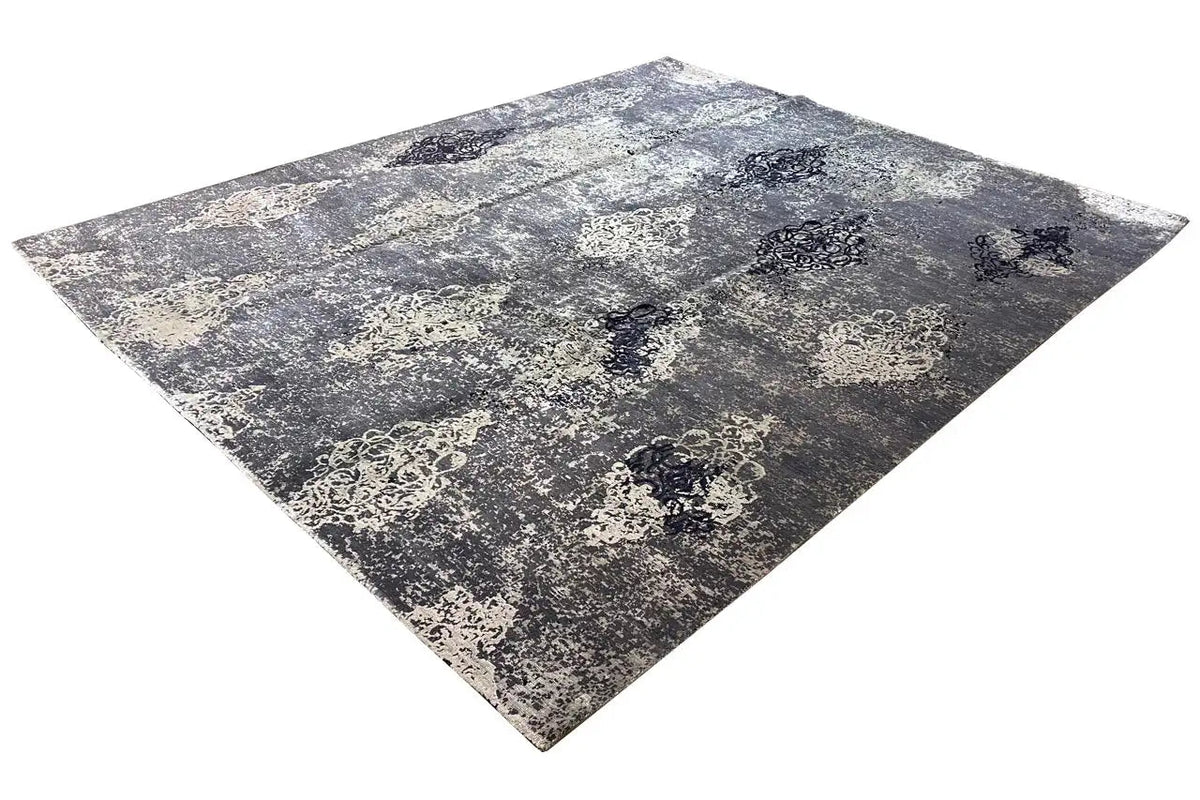 Designer rug with a blue-gray mottled surface pattern and vintage medallions