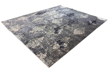 Designer rug with a blue-gray mottled surface pattern and vintage medallions