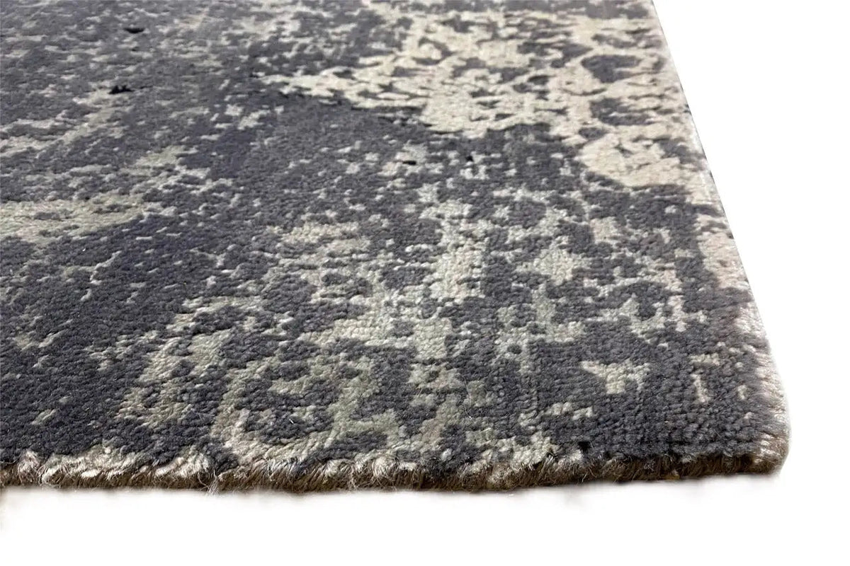 Designer rug with pile and fringe border along the edge, blue-gray pattern