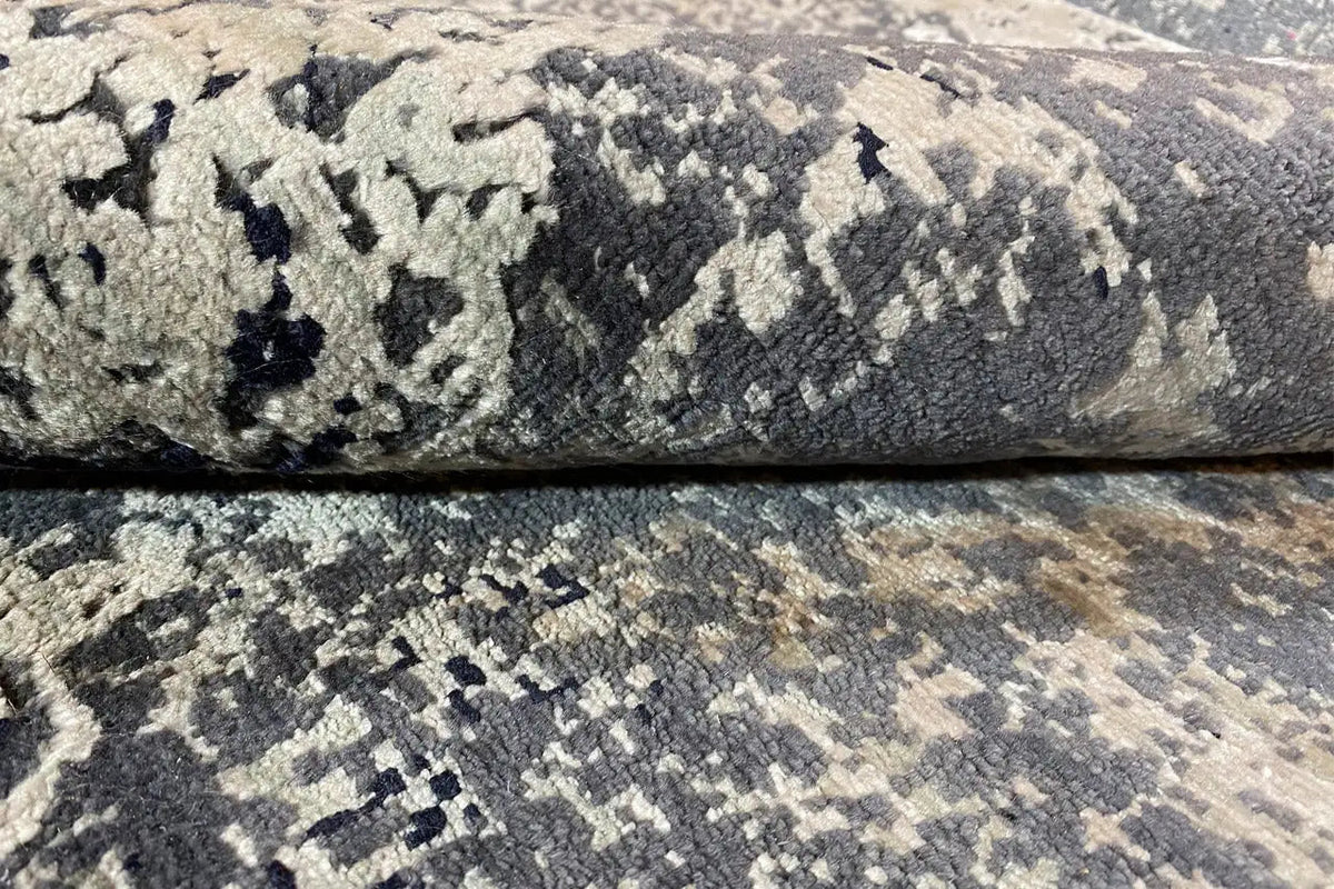 Designer rug close-up: blue-gray texture with an ornamental color gradient