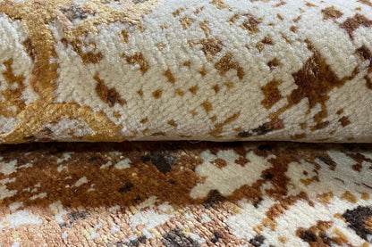 Designer rug detail: brown-gold and white areas with an abstract relief pattern