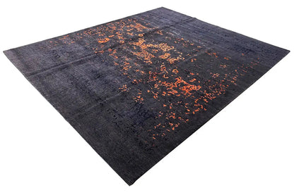 Dark blue rug with an abstract orange speckled pattern; rectangular, beveled edges