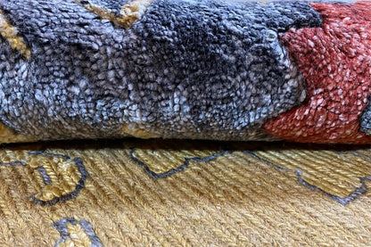Designer rug detail: mottled pile texture in blue, red and beige