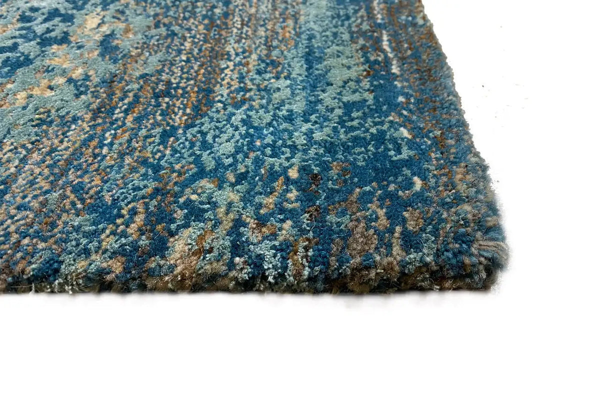 Designer rug corner view with blue pile and dense, fine short pile