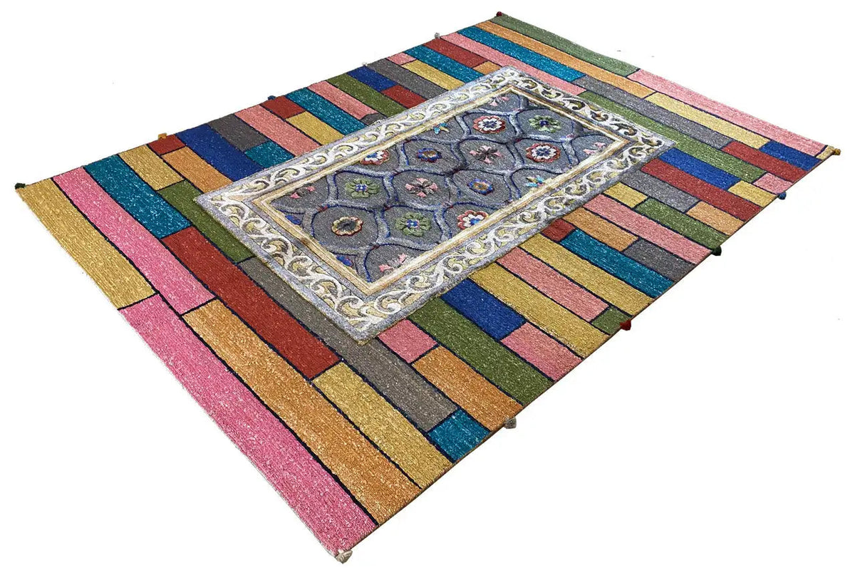 Colorful striped rug with a central gray-blue ornament