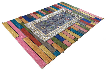 Colorful striped rug with a central gray-blue ornament
